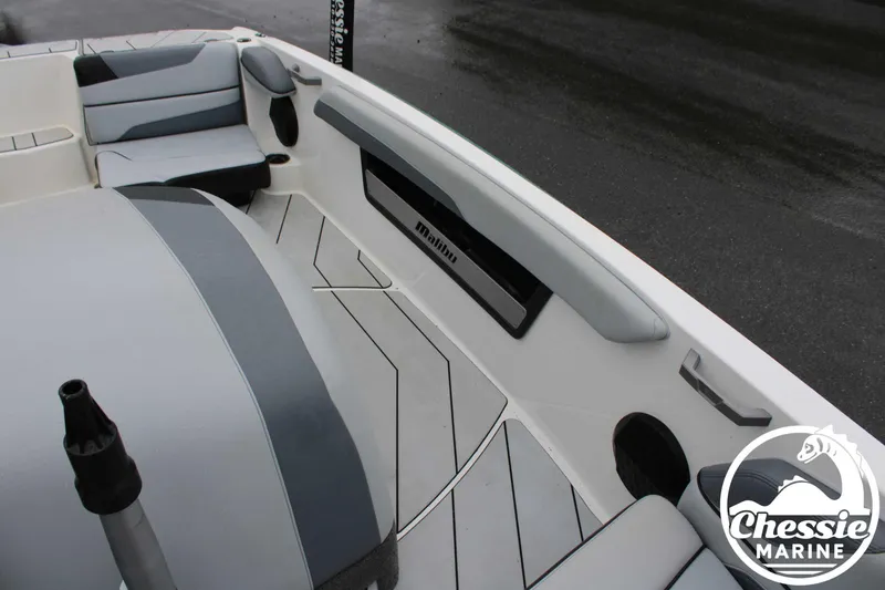 Slide: The Image of 2024 Malibu TXi Mo boat interior with sleek seating and modern design. - 8