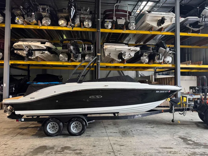 Slide: The Image of 2024 Sea Ray 230SPX boat on trailer in storage facility. - 1