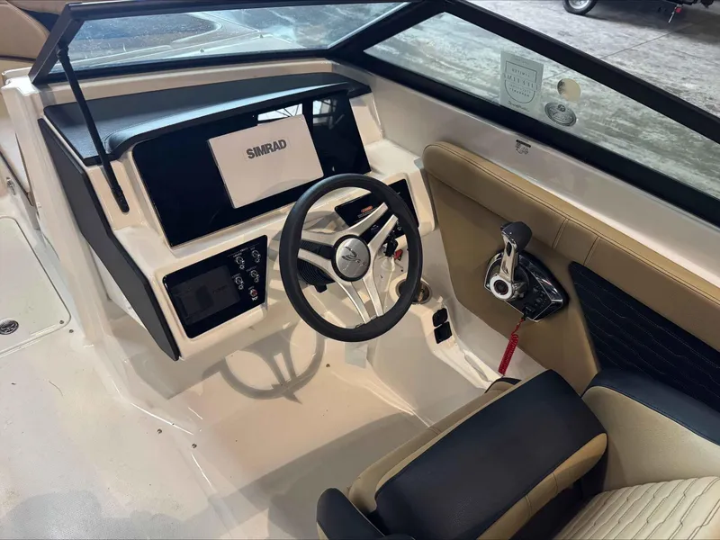 Slide: The Image of 2024 Sea Ray 230SPX boat cockpit with steering wheel and control panel. - 10