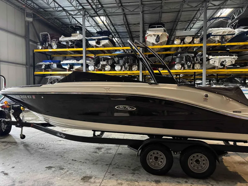 Slide: The Image of 2024 Sea Ray 230SPX boat on trailer in indoor storage facility. - 2