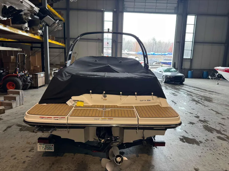 Slide: The Image of 2024 Sea Ray 230SPX boat in a warehouse, covered and ready for transport. - 4