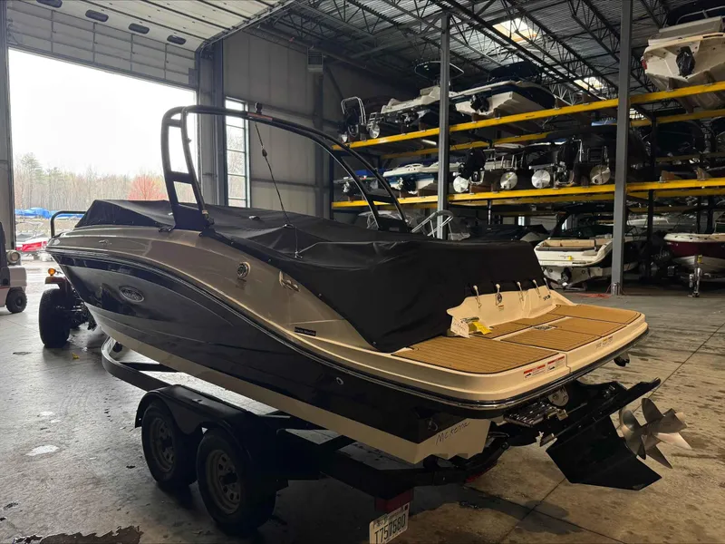 Slide: The Image of 2024 Sea Ray 230SPX boat in storage, covered and on a trailer. - 6