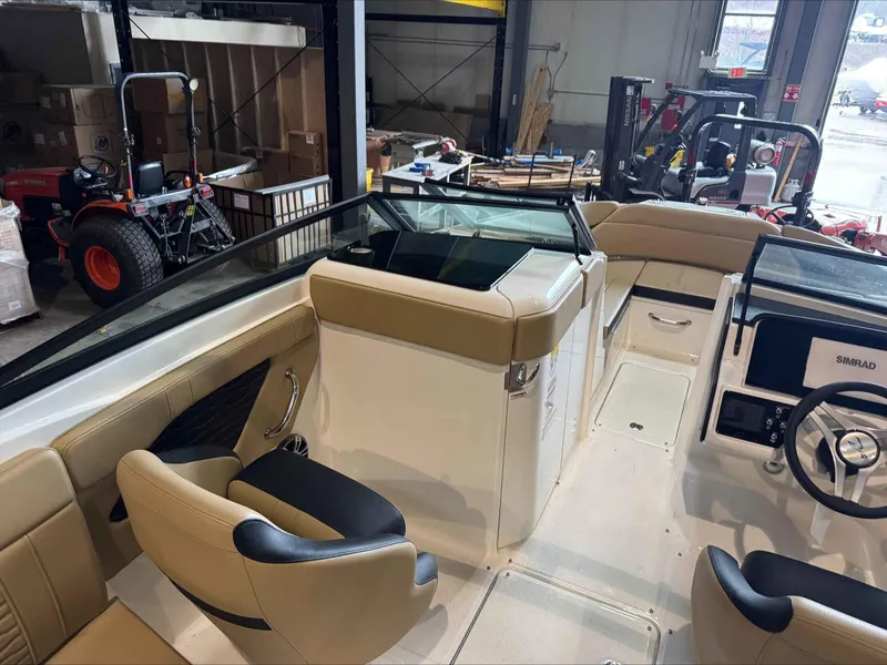 Slide: The Image of 2024 Sea Ray 230SPX boat interior with beige seating and modern dashboard. - 7