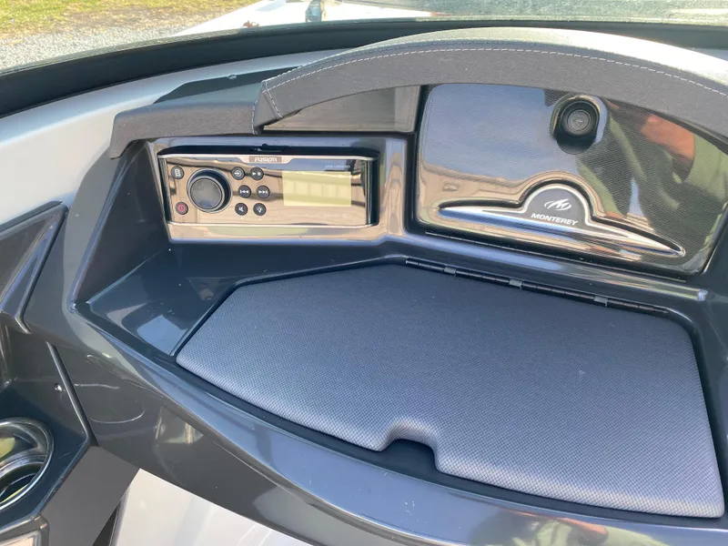 Slide: The Image of 2020 Monterey 238 Super Sport dashboard with stereo system and storage compartment. - 16