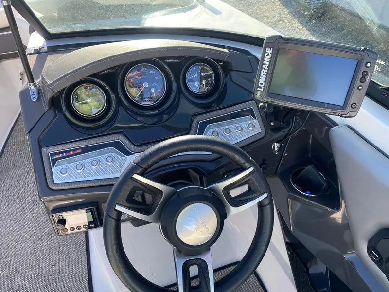 Slide: The Image of Cockpit of 2020 Monterey 238 Super Sport boat with steering wheel and navigation system. - 17