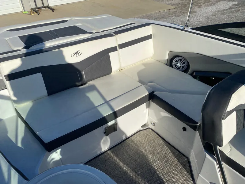 Slide: The Image of 2020 Monterey 238 Super Sport boat interior with cushioned seating and speaker. - 20
