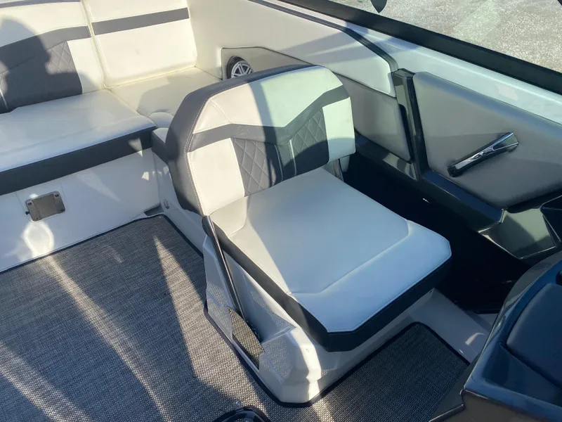 Slide: The Image of 2020 Monterey 238 Super Sport boat interior with white and gray seating. - 23