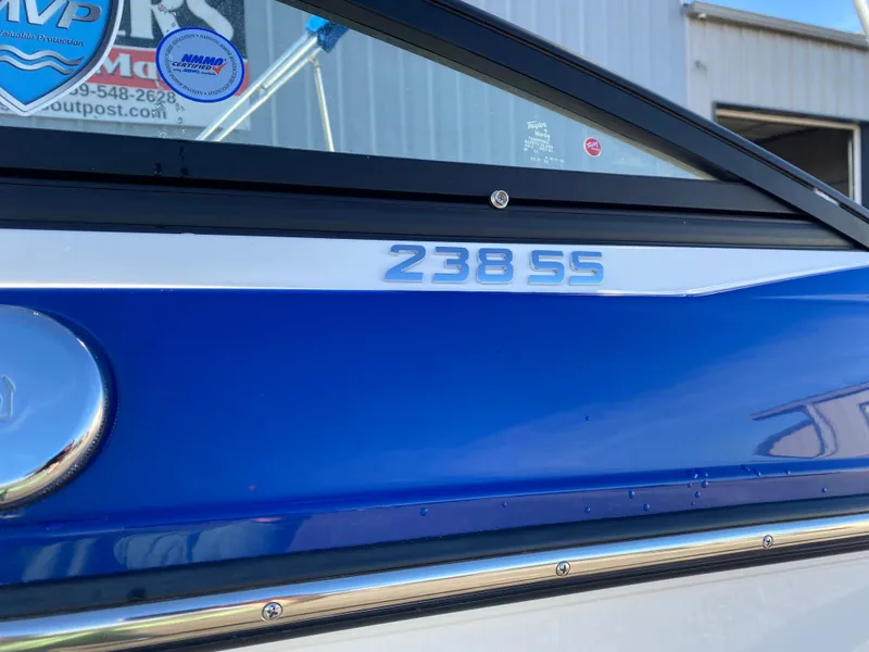 Slide: The Image of 2020 Monterey 238 Super Sport boat, blue and white exterior, close-up view. - 4