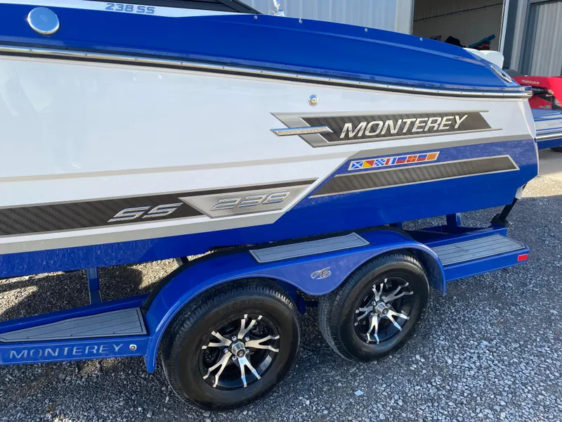Slide: The Image of 2020 Monterey 238 Super Sport boat on trailer, blue and white design. - 5