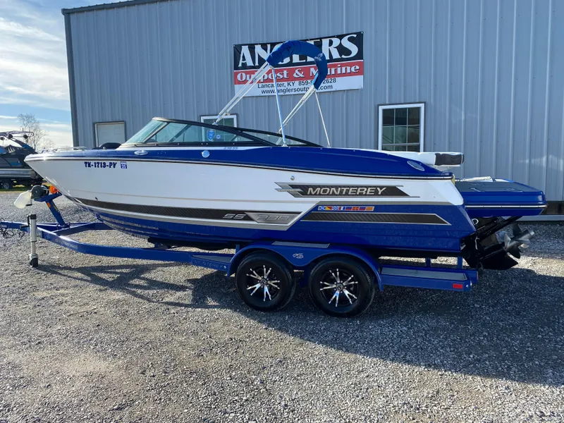 Slide: The Image of 2020 Monterey 238 Super Sport boat on trailer, parked outside Anglers Outpost & Marine. - 6