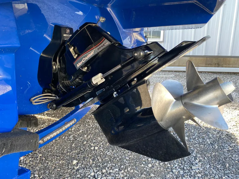 Slide: The Image of 2020 Monterey 238 Super Sport boat with MerCruiser outdrive and propeller, parked on gravel. - 7