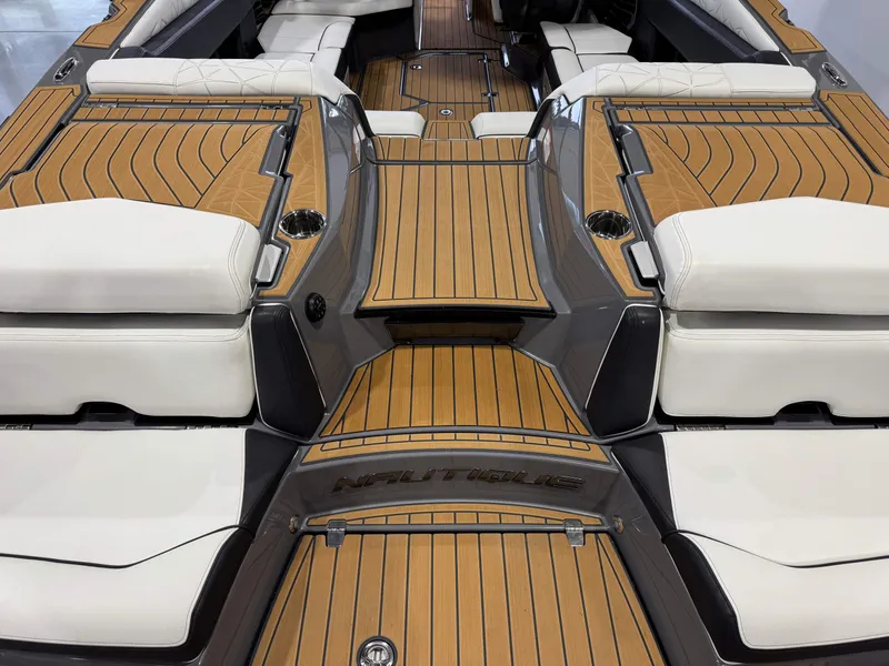 Slide: The Image of 2023 Nautique Super Air Nautique G23 Paragon interior with luxurious seating and teak flooring. - 10