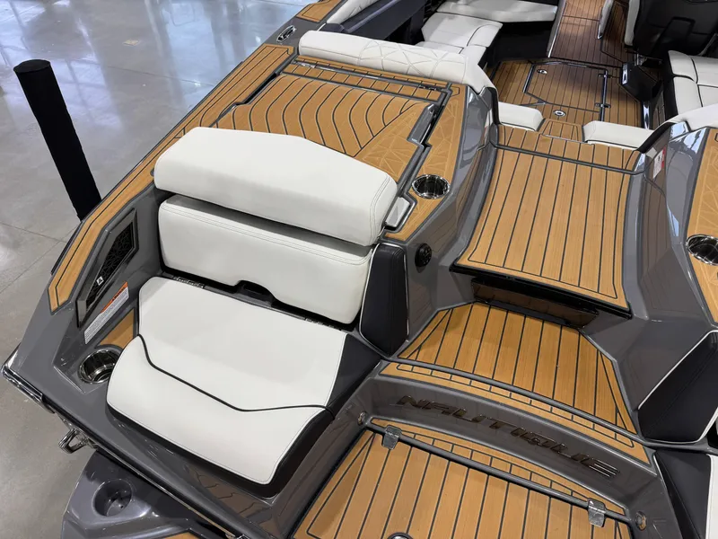 Slide: The Image of 2023 Nautique Super Air Nautique G23 Paragon interior with teak flooring and white seating. - 12