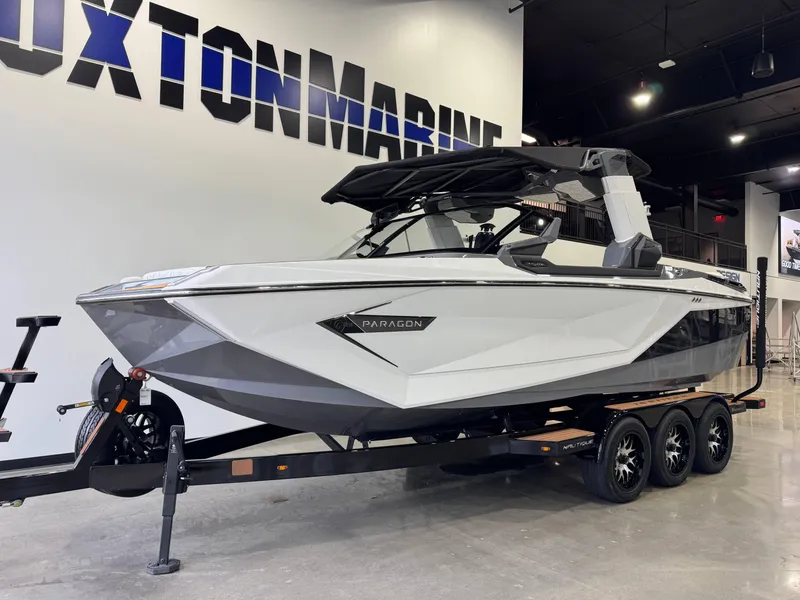 Slide: The Image of 2023 Nautique Super Air Nautique G23 Paragon boat displayed indoors on a trailer. - 3