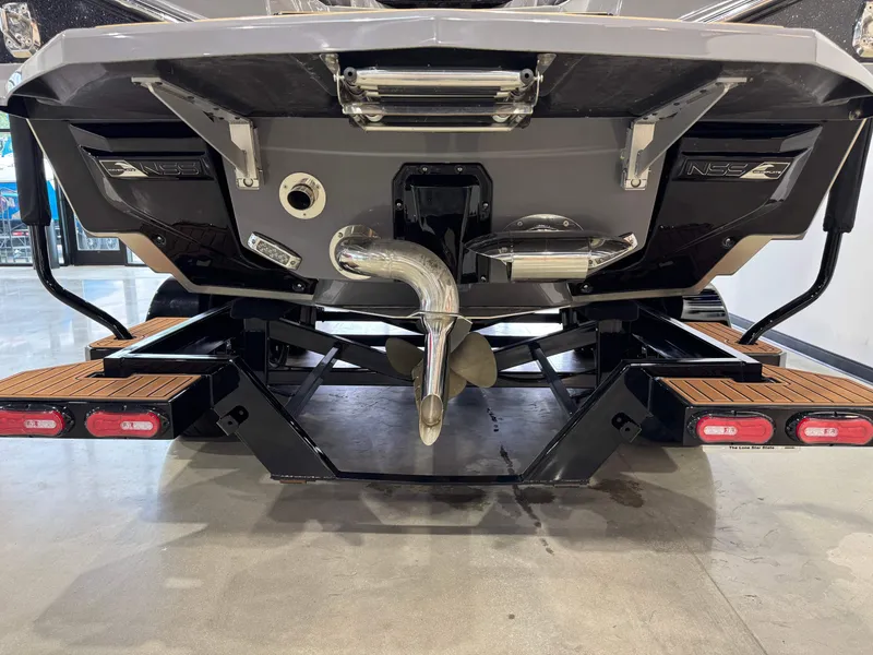 Slide: The Image of 2023 Nautique Super Air Nautique G23 Paragon boat rear view, showcasing propeller and exhaust system. - 7