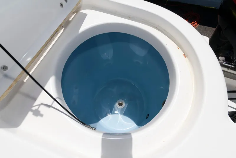 Slide: The Image of Livewell on 2016 Tidewater 230 CC Adventure boat, featuring a blue interior. - 14