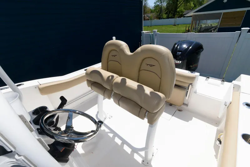 Slide: The Image of 2016 Tidewater 230 CC Adventure boat interior with dual seats and steering wheel. - 9