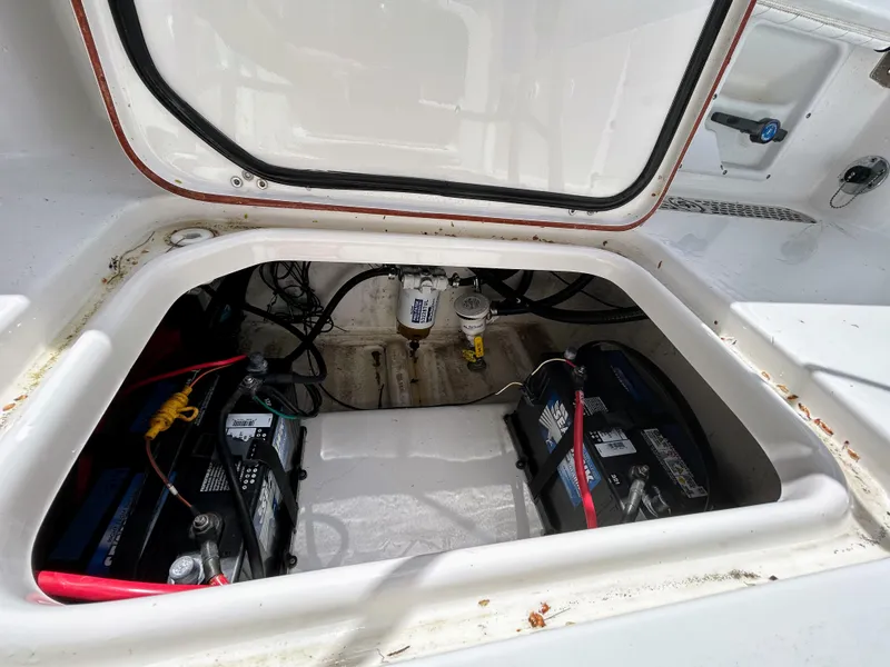 Slide: The Image of 2017 Sea Pro 219 Center Console battery compartment with wiring and components visible. - 12