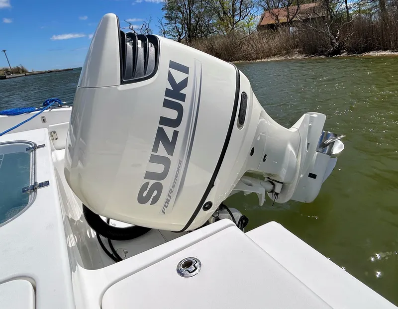 Slide: The Image of 2017 Sea Pro 219 Center Console with Suzuki outboard motor on a sunny day. - 13