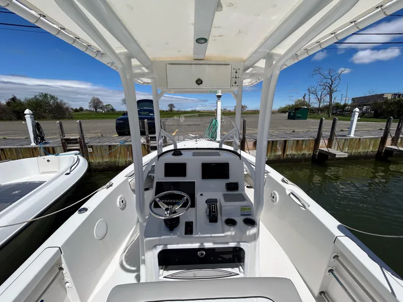Slide: The Image of 2017 Sea Pro 219 Center Console boat docked, showcasing helm and controls. - 4