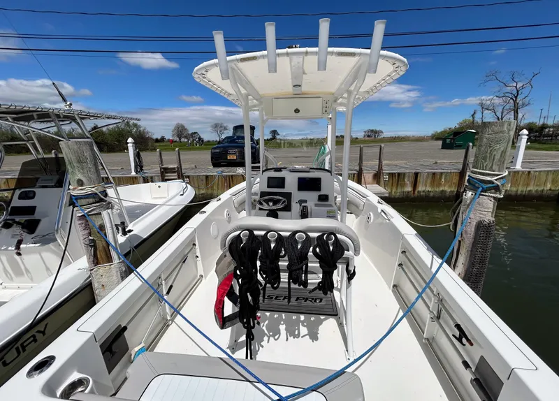 Slide: The Image of 2017 Sea Pro 219 Center Console boat docked, featuring a spacious deck and modern controls. - 5