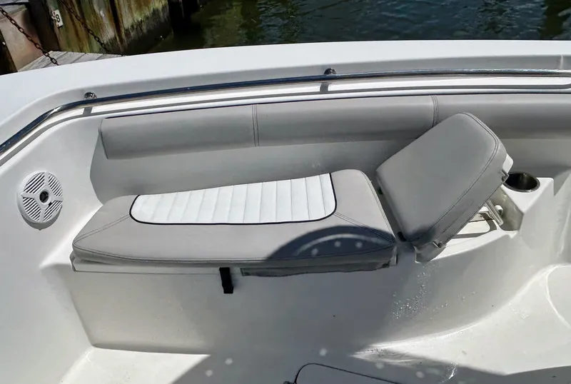 Slide: The Image of 2017 Sea Pro 219 Center Console boat seating with cushioned backrest and speaker. - 7