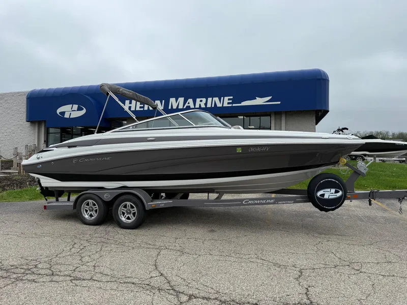 Slide: The Image of 2018 Crownline 235 SS boat on trailer outside marine dealership. - 0
