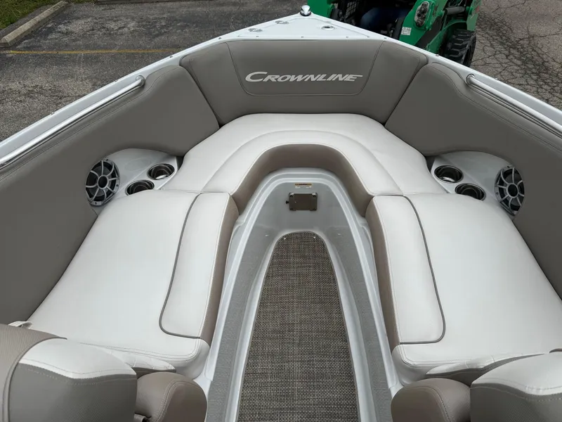 Slide: The Image of 2018 Crownline 235 SS boat interior with beige seating and cup holders. - 2