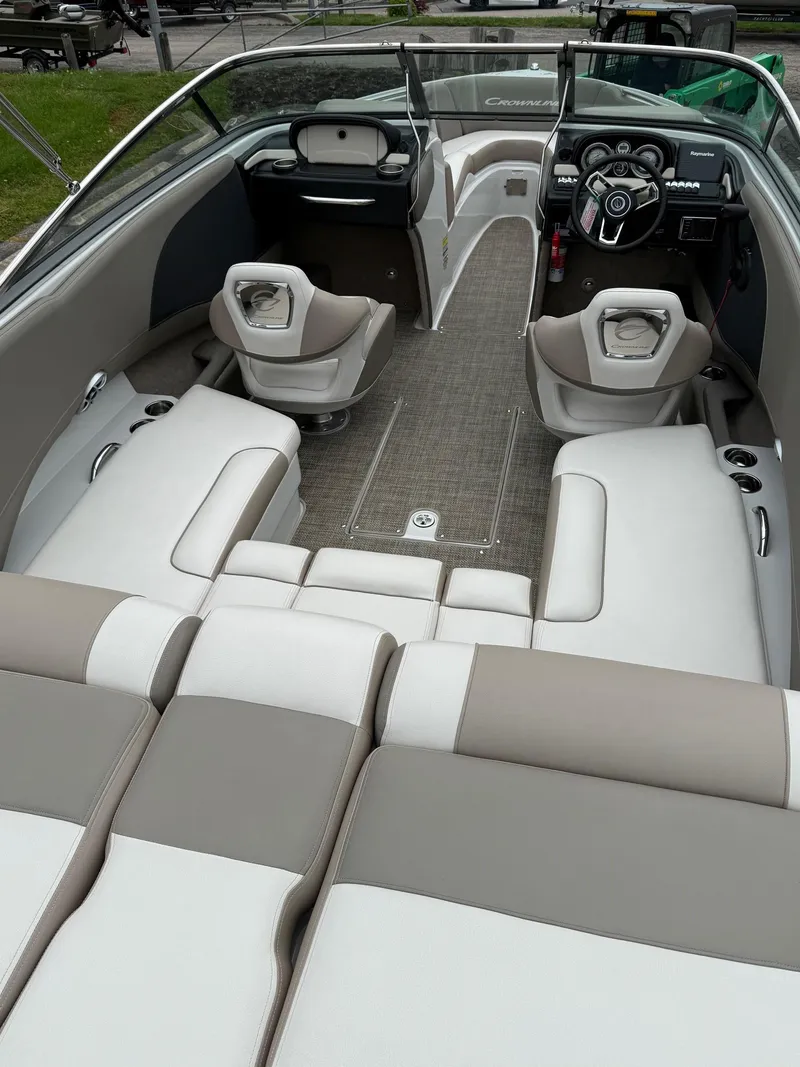 Slide: The Image of 2018 Crownline 235 SS boat interior with plush seating and modern dashboard. - 4