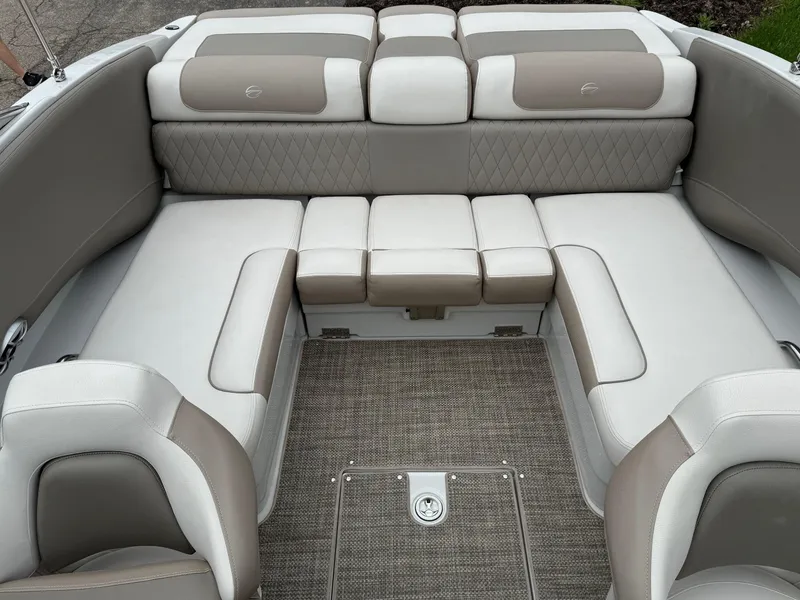 Slide: The Image of 2018 Crownline 235 SS boat interior with beige and white cushioned seating. - 6