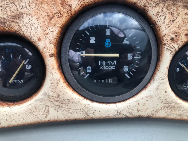 Slide: The Image of Dashboard gauges of a 1997 Chaparral 1930 SS boat, showing RPM and trim levels. - 10