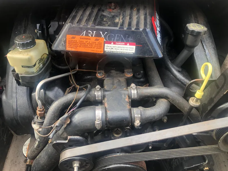 Slide: The Image of Engine of a 1997 Chaparral 1930 SS boat, featuring visible components and warning labels. - 11