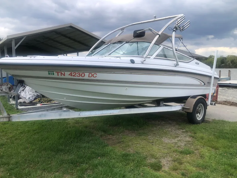 Slide: The Image of Chaparral 1930 SS 1997 boat on trailer, parked on grass under cloudy sky. - 3