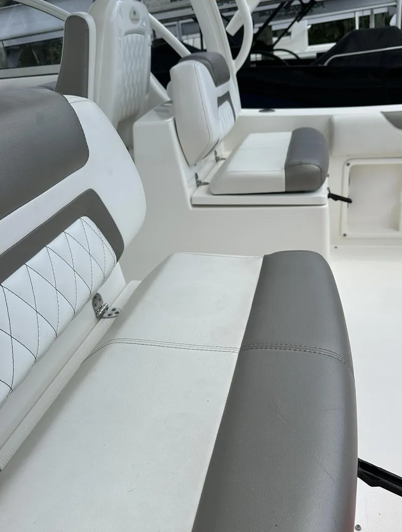 Slide: The Image of 2021 World Cat 255 DC boat interior with gray and white seating. - 13