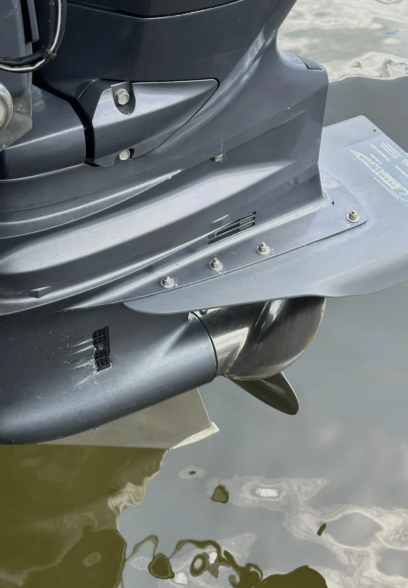 Slide: The Image of Close-up of a 2021 World Cat 255 DC boat motor in water. - 15