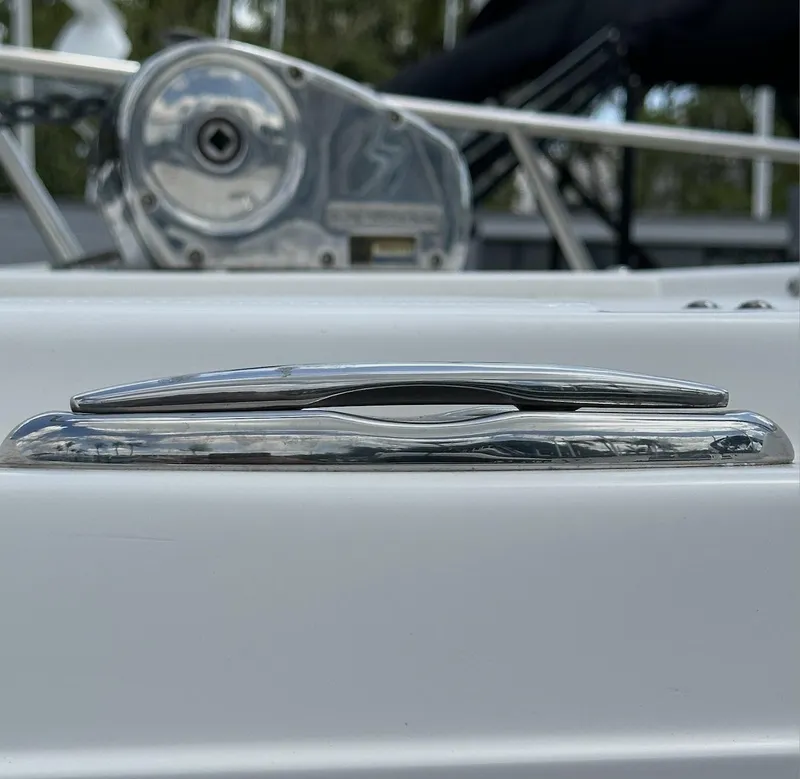 Slide: The Image of Close-up of a 2021 World Cat 255 DC boat cleat, showcasing sleek chrome design. - 16
