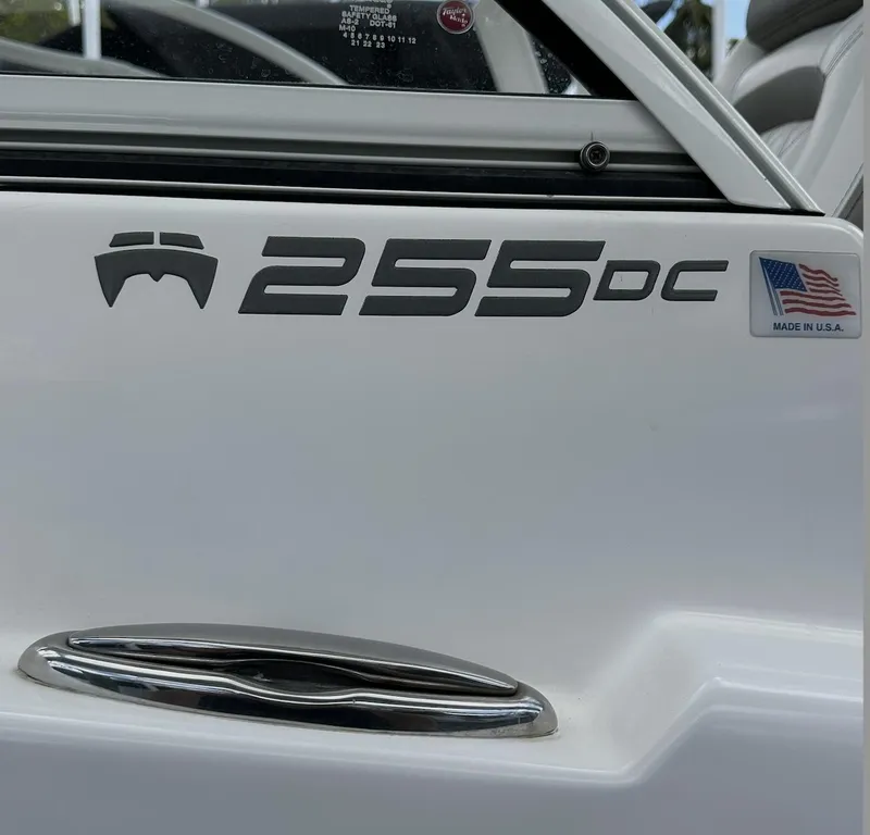 Slide: The Image of 2021 World Cat 255 DC boat with American flag sticker, close-up view. - 19