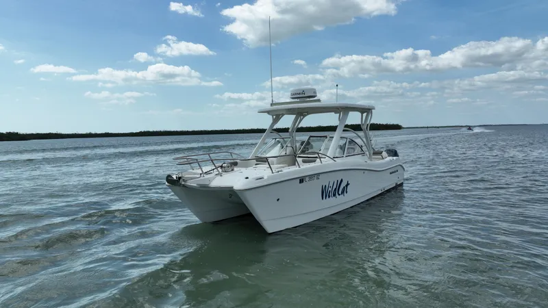 Slide: The Image of 2021 World Cat 255 DC boat on open water under a clear sky. - 2