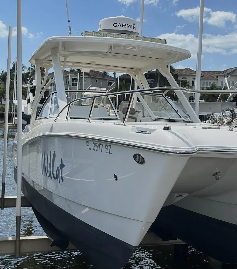 Slide: The Image of 2021 World Cat 255 DC boat docked, featuring Garmin equipment, with a clear sky background. - 26