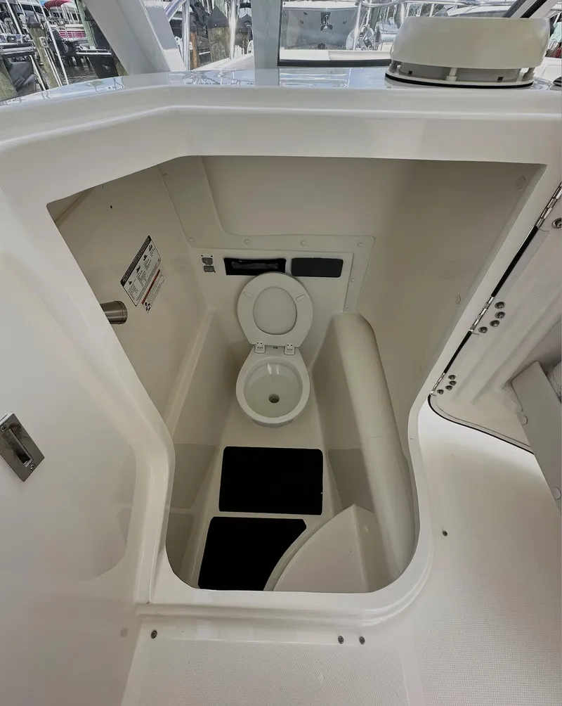Slide: The Image of 2021 World Cat 255 DC boat interior with compact marine toilet. - 31