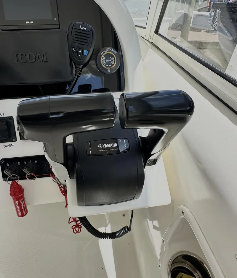 Slide: The Image of Yamaha throttle controls on a 2021 World Cat 255 DC boat dashboard. - 36