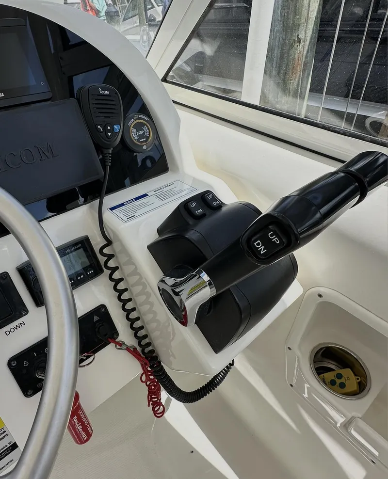 Slide: The Image of 2021 World Cat 255 DC helm with controls, gauges, and communication equipment. - 37