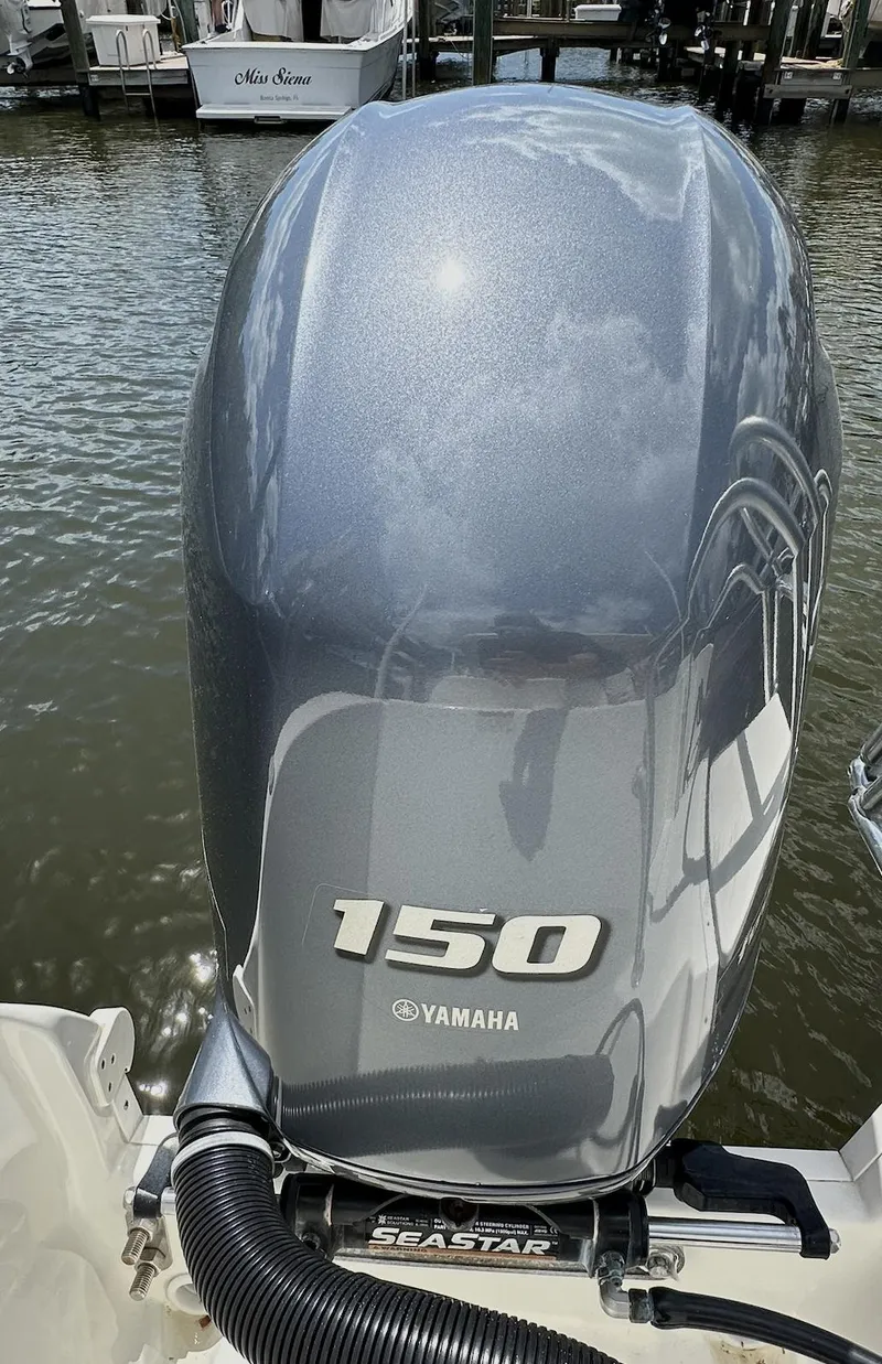 Slide: The Image of Yamaha 150 outboard motor on 2021 World Cat 255 DC boat, docked by the water. - 38