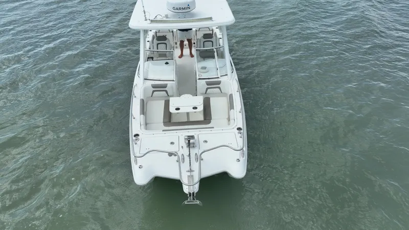 Slide: The Image of 2021 World Cat 255 DC boat on water, aerial view, showcasing spacious deck and seating. - 4