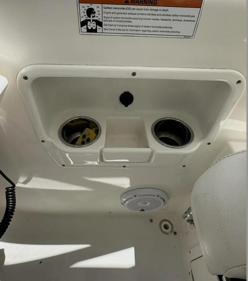 Slide: The Image of 2021 World Cat 255 DC boat interior with cup holders and speaker. - 40