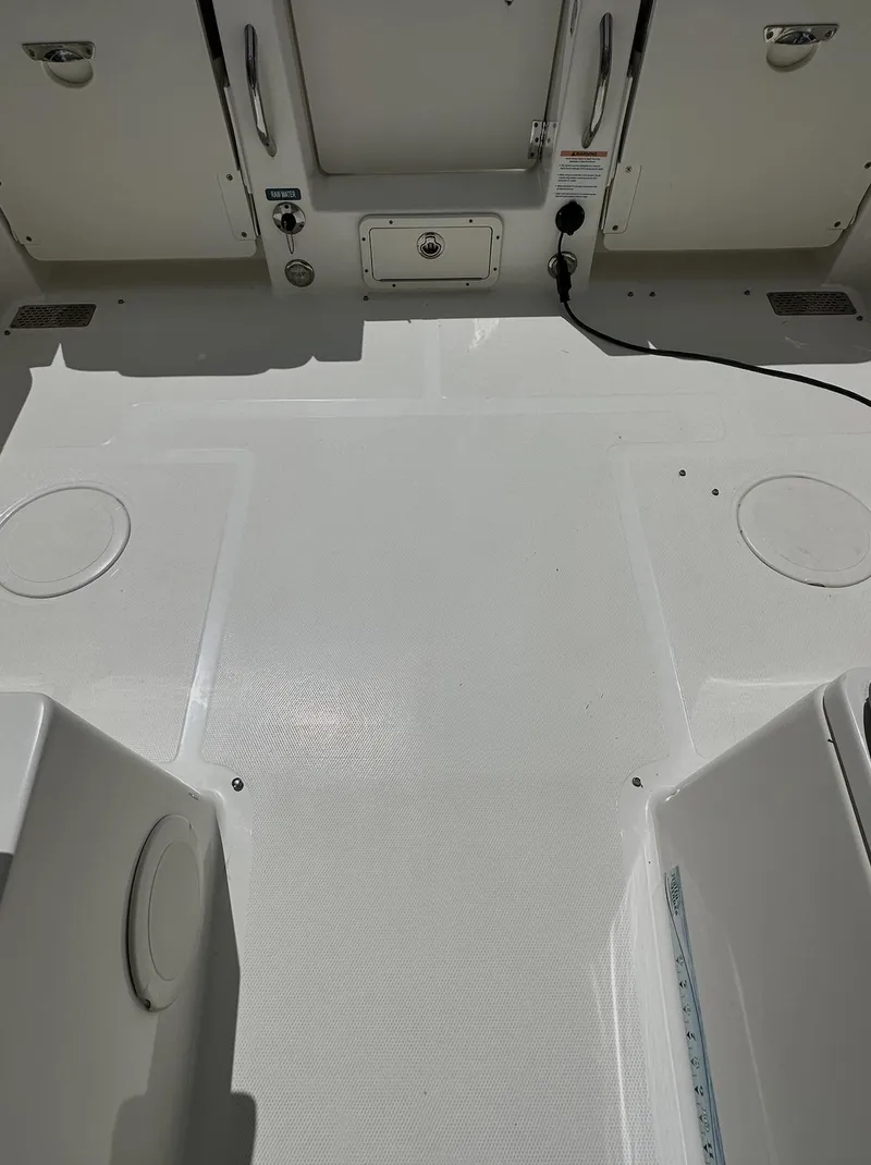 Slide: The Image of 2021 World Cat 255 DC boat deck, featuring a clean, spacious layout with storage compartments. - 41