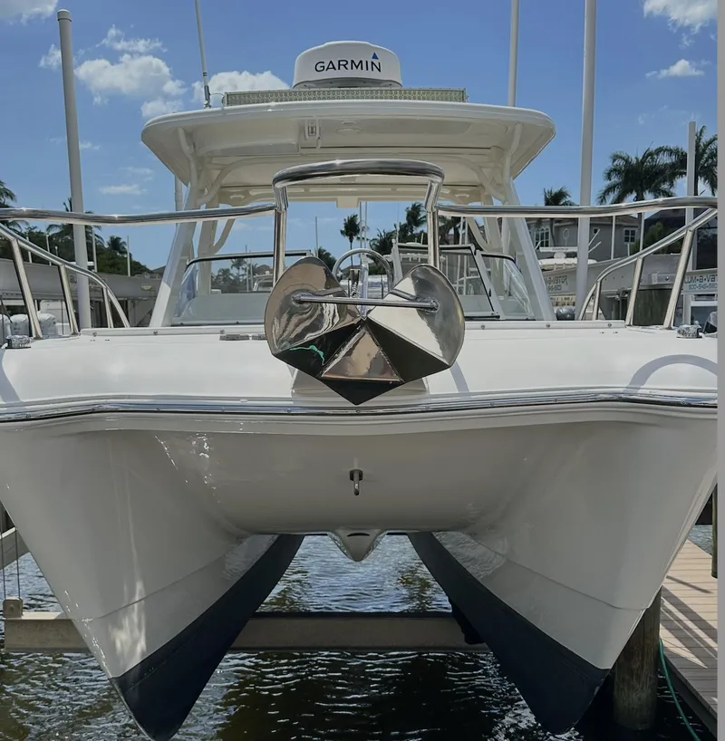 Slide: The Image of 2021 World Cat 255 DC boat docked, featuring Garmin equipment, under a clear blue sky. - 9