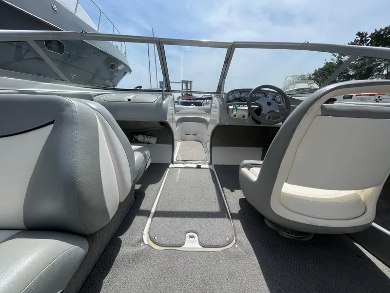 Slide: The Image of Interior of a 2011 Bayliner 195 boat, featuring seating and steering wheel. - 16