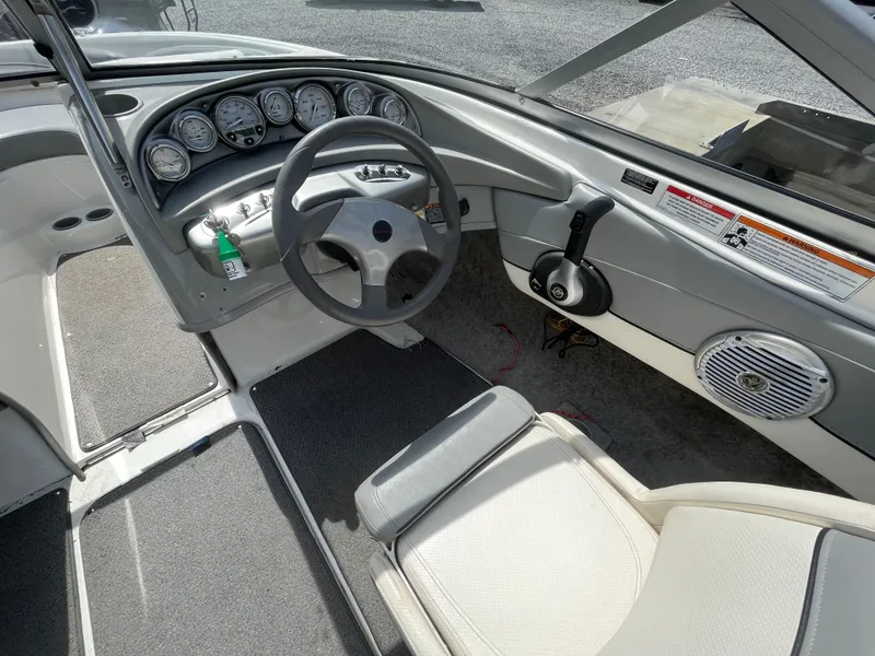 Slide: The Image of 2011 Bayliner 195 boat interior with steering wheel, dashboard, and seating. - 17