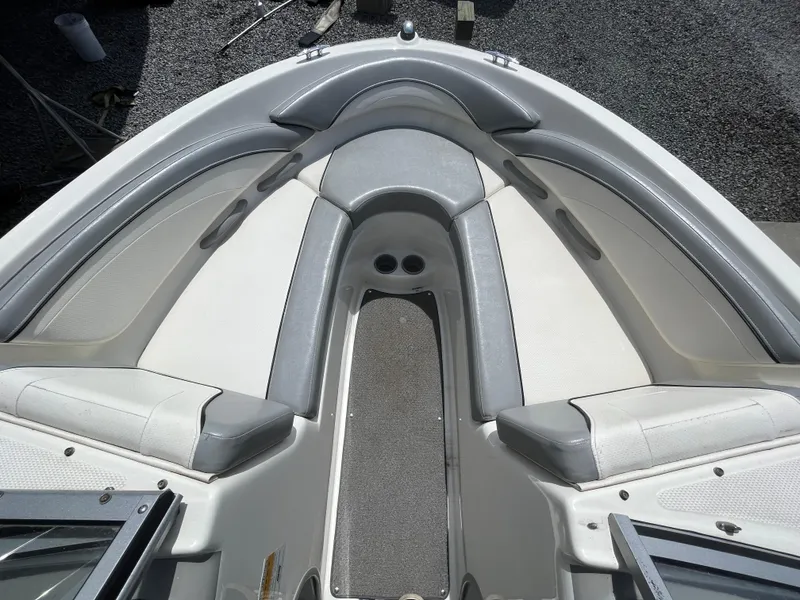 Slide: The Image of 2011 Bayliner 195 boat interior with gray and white seating, viewed from above. - 18